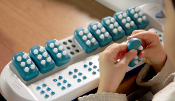 Taptilo Braille teaching device being used by a child.